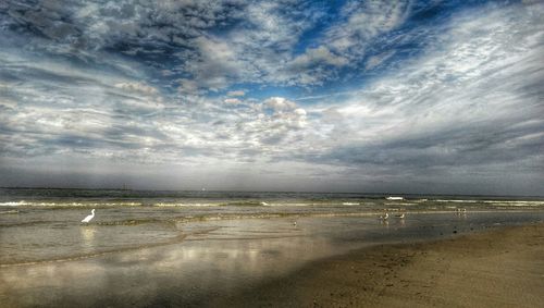 Scenic view of sea against cloudy sky