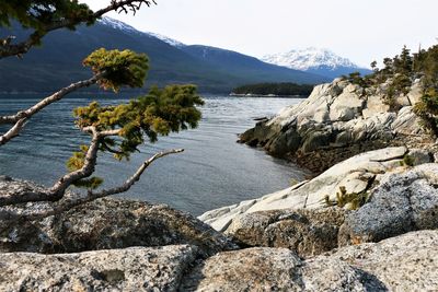 Scenic view of sea and mountains against sky