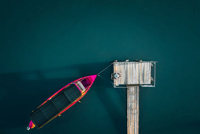 Aerial view of man and fishing boat by pier