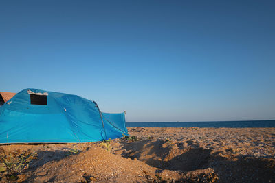 Scenic view of beach against clear blue sky