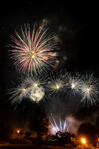 Low angle view of firework display at night