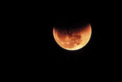 Low angle view of moon against clear sky at night