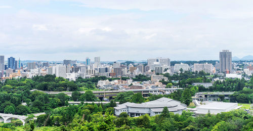 High angle view of buildings in city against sky