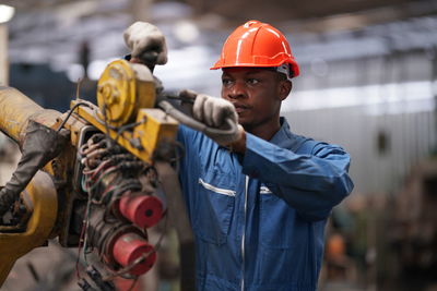 Rear view of man working at construction site