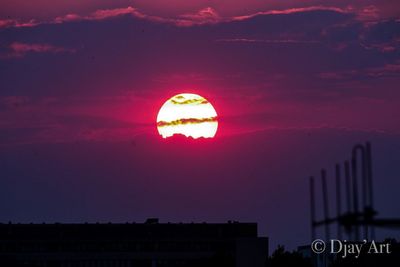 Silhouette buildings against sky during sunset