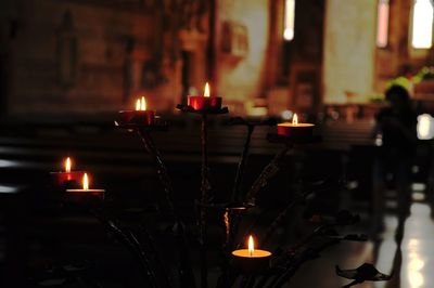 Illuminated candles in church