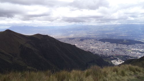 Scenic view of mountains against cloudy sky