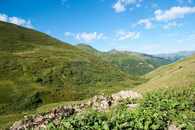 Scenic view of valley and mountains against sky