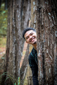 A pine tree with a young man in black