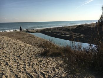 Scenic view of beach against clear sky