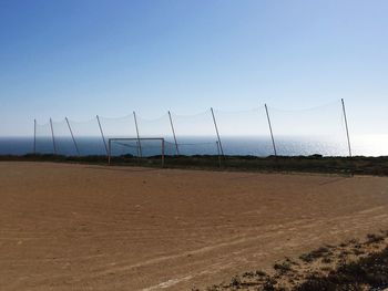 Scenic view of beach against clear blue sky