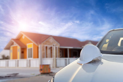 Close-up of white car against building