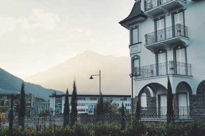 Low angle view of buildings against cloudy sky