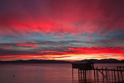 Scenic view of sea against orange sky