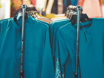 Close-up of clothes hanging on rack in store