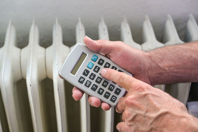 Cropped hand of person using calculator