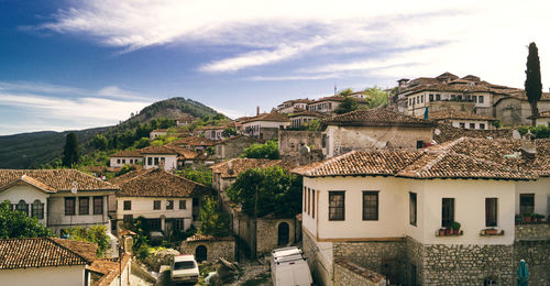 Houses in town against sky