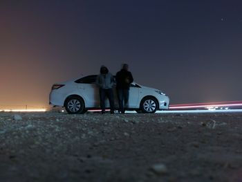 People on car at night
