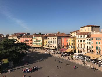 High angle view of people on road by buildings against sky