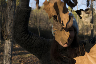 Close-up portrait of woman covering face