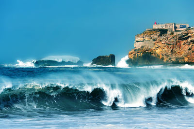 Scenic view of sea against clear blue sky