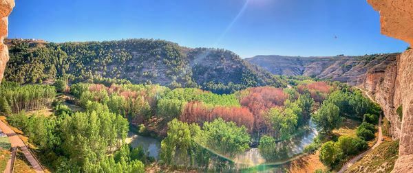 Scenic view of trees and mountains against sky