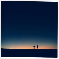 Silhouette of woman standing on field