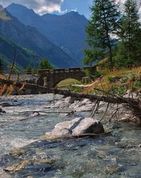 Scenic view of river by mountains