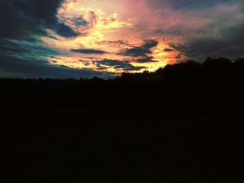 Silhouette of landscape against cloudy sky