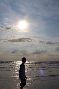 Full length of boy on beach against sky