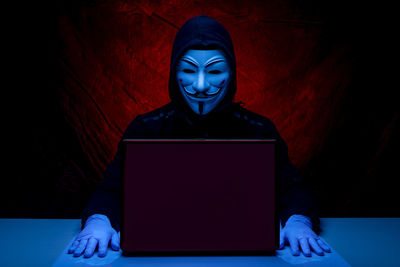 Portrait of man using laptop on table