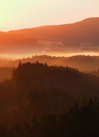 Beautiful green hills glowing by warm sunlight at twilight.