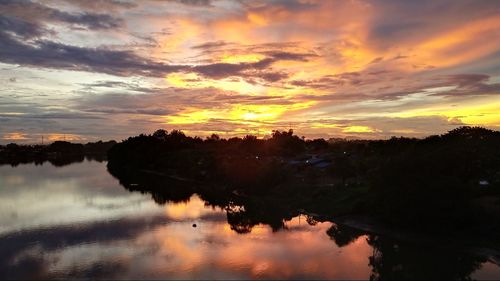 Scenic view of lake against orange sky