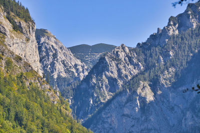 Scenic view of rocky mountains against clear blue sky