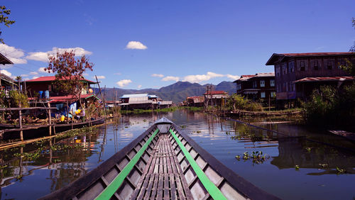 Panoramic view of swimming pool by building against sky