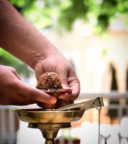 Cropped image of man preparing hookah 