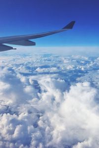 Aerial view of cloudscape over airplane wing