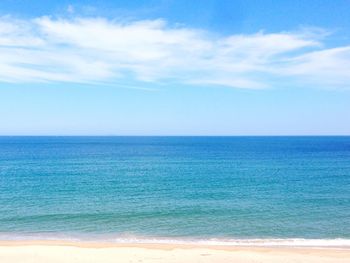 Scenic view of sea against blue sky