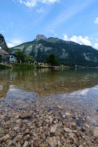 Scenic view of lake by building against sky