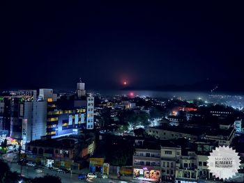 High angle view of illuminated buildings in city at night