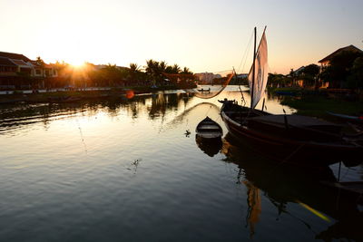 Boats moored at sunset