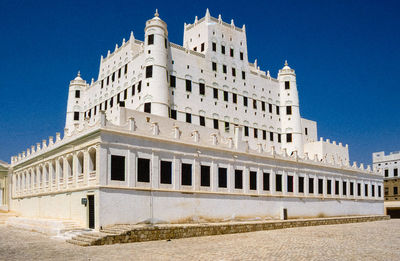 Low angle view of building against blue sky