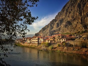 Houses in a lake with mountain range in the background