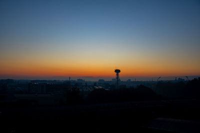 Silhouette buildings against sky during sunset