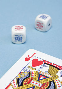 Close-up of card and dice on table