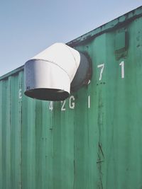 Low angle view of electric lamp against blue sky