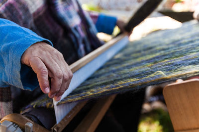 Close-up of hand working on wood