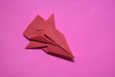 Close-up of paper toy against pink background