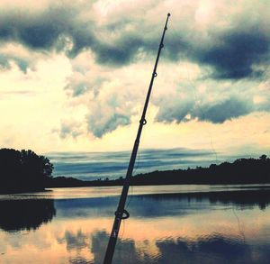 Scenic view of lake against cloudy sky