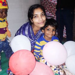 Portrait of happy girl with balloons